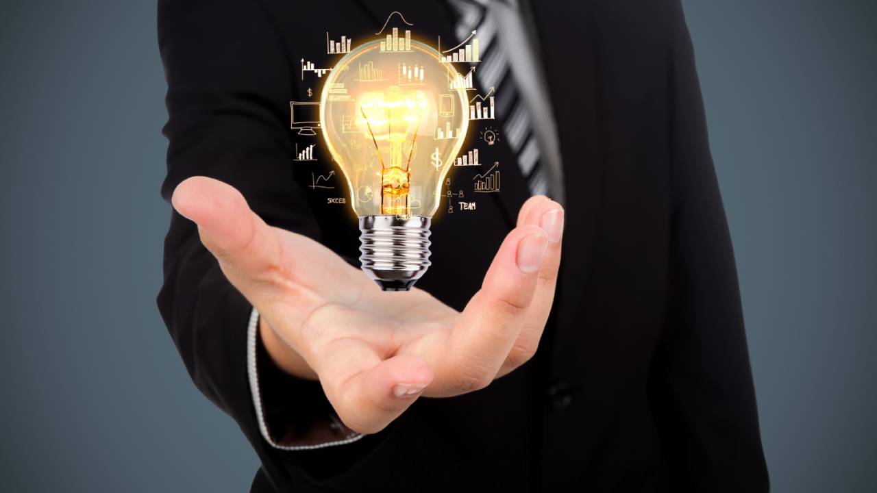 A businessman holding a bulb representing the various online business ideas in Dubai.