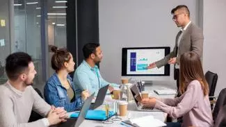 A Business Consultancy in Dubai team presenting a report to their clients A Business Consultancy in Dubai team presenting a report to their clients